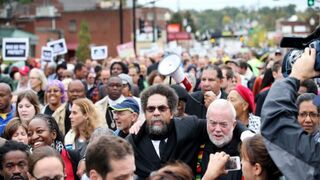 Author and activist Cornel West (center) amid protesters rallying in Ferguson, Mo., Oct. 13, 2014, in the months following the August 2014 fatal police shooting of Michael Brown. West is among a group of black activists advocating for U.S. divestment in Israel on behalf of the Palestinian people.Scott Olson/Getty Images