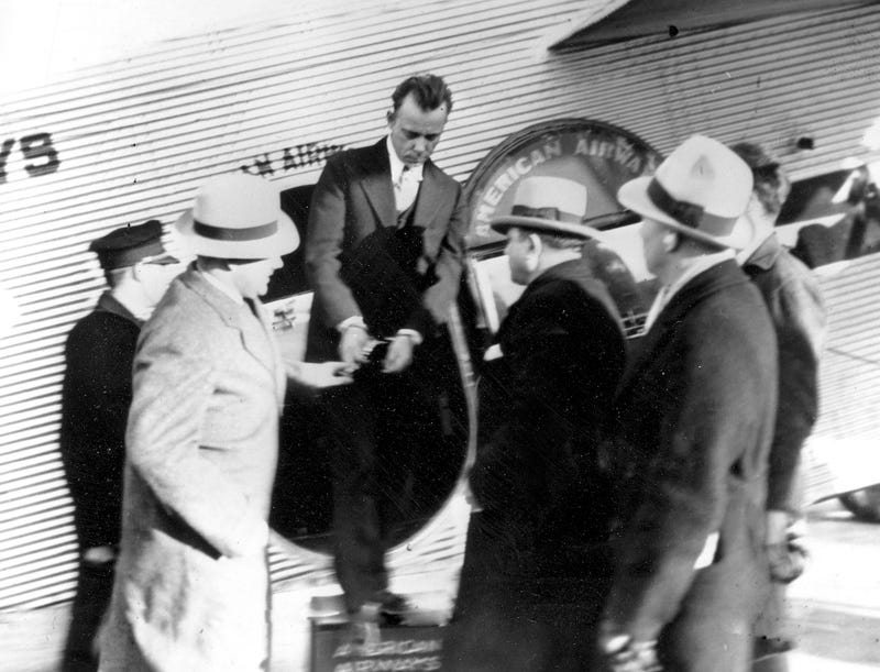 John Dillinger is shown on January 30, 1934, as he’s taken from one plane to another in St. Louis, Tennessee on his way to an Indiana jail