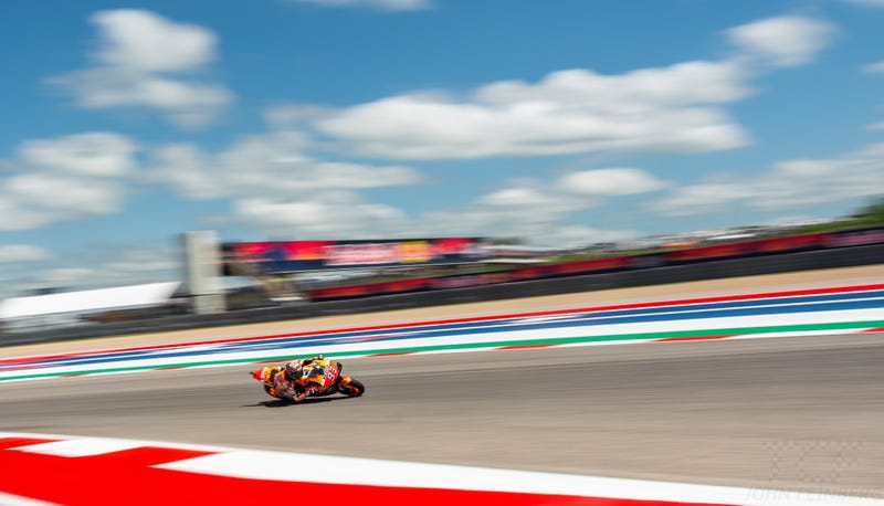 Marc Marquez flies around a damp track to grab the pole position during qualifying.