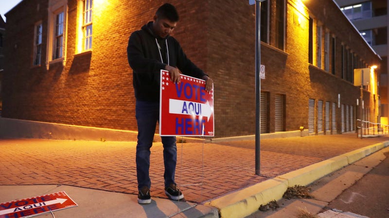 Volunteer Albert Lopez, 18, puts up a Spanish-language voting sign in El Paso, Texas, a predominantly Latinx border town that voted blue this year.