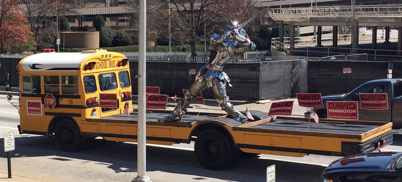 Illustration for article titled Flat-Bed School Bus Carries Chrome Knight, Political Message Around GA