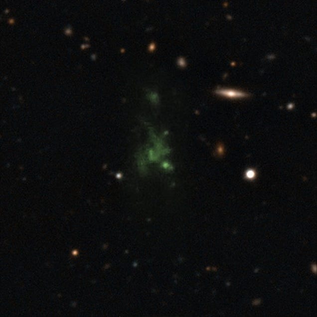 Lyman-alpha blob (LAB-1) pictured at the center is one of the largest known objects in the universe. Because of its distance, the blob’s UV emissions get stretched on their journey through space and appear green to our telescopes. Image: ESO/M. Hayes
