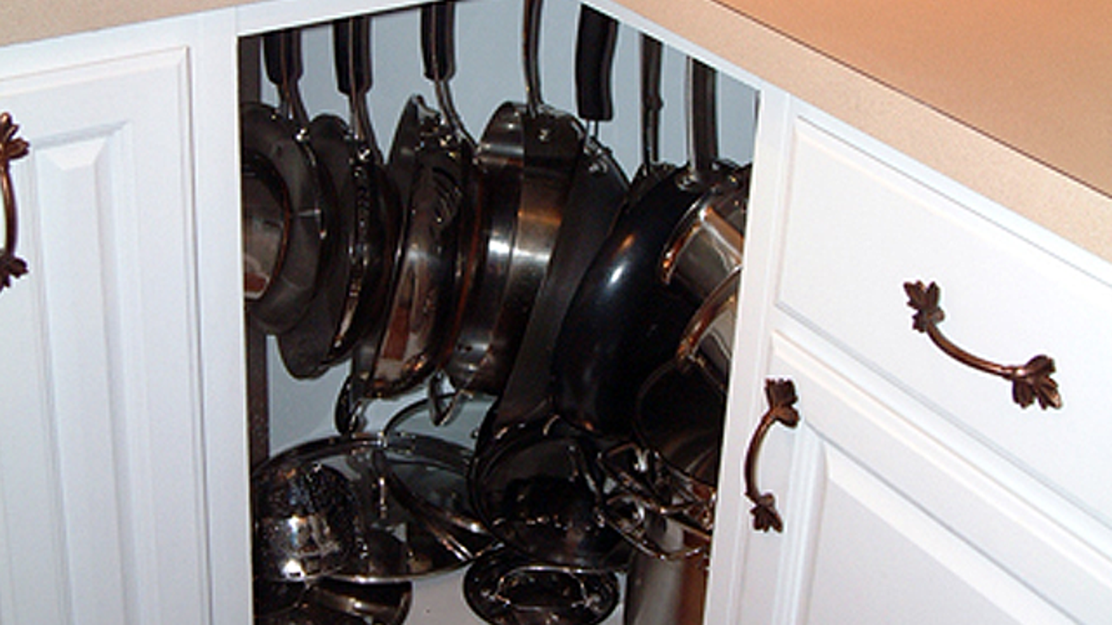 Hang Pots And Pans In Corner Cabinets To Make Better Use Of Them