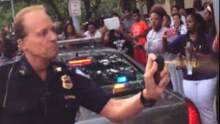 A Cleveland transit police officer is shown here using pepper spray on several attendees at the National Convening of the Movement for Black Lives.Twitter