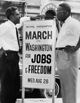 Bayard Rustin (left) speaks with fellow march organizer Cleveland Robinson. (Wikimedia Commons)