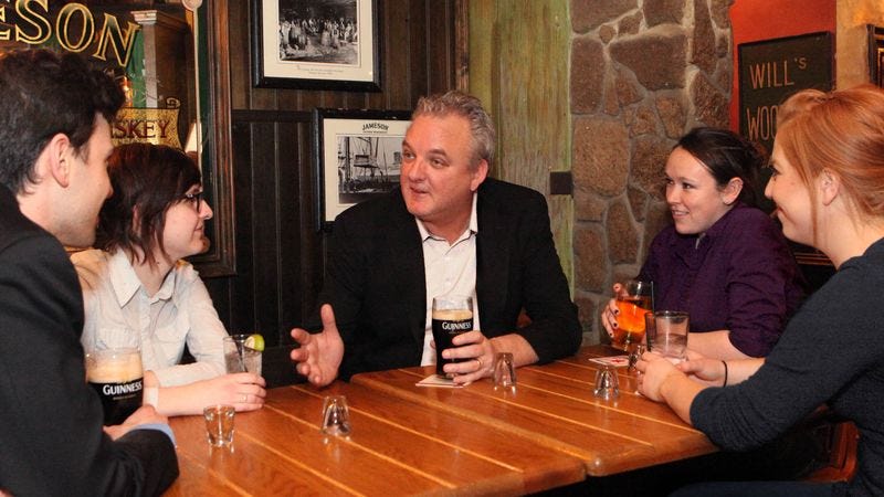 Hushed coworkers gather to hear tell of Plasky’s legendary incompetence.