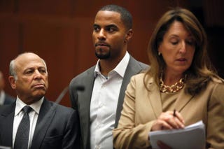 Former pro football player Darren Sharper appears in Los Angeles court, along with his attorneys Leonard Levine and Blair Berk, Feb. 14, 2014.Liz O. Baylen-Pool/Getty Images