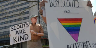 Oliver Tessier holds a sign as he protests for equality within the Boy Scouts of America. (Matt McClain/the Washington Post)