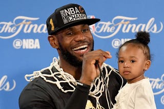 LeBron James of the Cleveland Cavaliers holds his daughter Zhuri during a press conference following the Cavs’ defeat of the Golden State Warriors 93-89 in Game 7 to win the 2016 NBA Finals June 19, 2016, in Oakland, Calif.Thearon W. Henderson/Getty Images