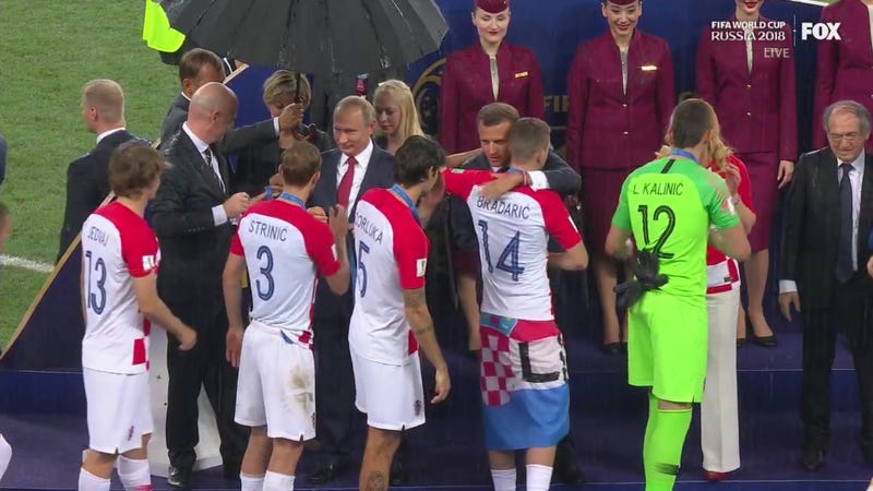 Illustration for article titled Let Us Congratulate Vladimir Putin For Victoriously Claiming The One Available Umbrella During World Cup Medal Ceremonies