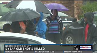 Family and friends gather outside the home where the young boy was killed.KHOU 11 screenshot