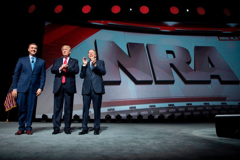 President Donald Trump (center) stands with National Rifle Association President Wayne LaPierre (right) and NRA-ILos Angeles Executive Director Chris Cox during the NRA Leadership Forum in Atlanta April 28, 2017. (Jim Watson/AFP/Getty Images)