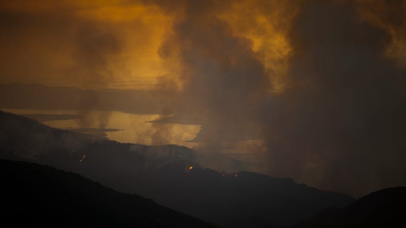 A wildfire burns next to Lake Cachuma on July 9, 2017 near Santa Barbara, California. Image via Getty.