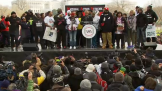 Rev. Al Sharpton on stage with families of slain young black men at Justice for All march in Washington, DC, December 13, 2014.Screenshot from NBC4
