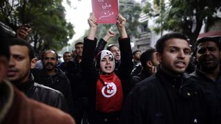 Tunisian protesters march during a demonstration.