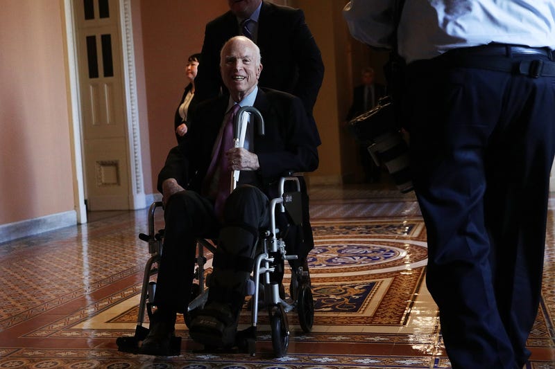 Sen. John McCain (R-Ariz.) passes by on a wheelchair in a hallway at the Capitol on Dec. 1, 2017, in Washington, D.C.