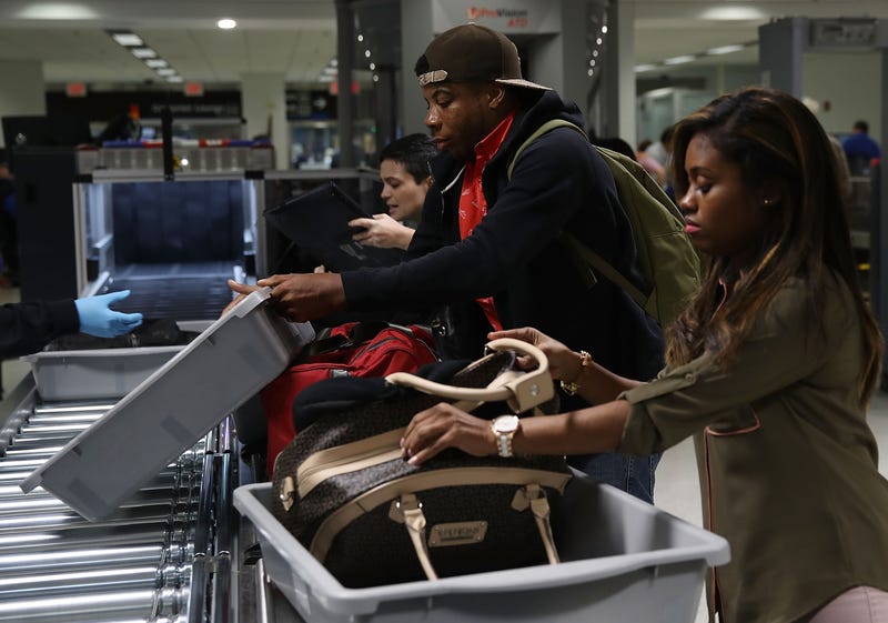 Travelers use the automated screening lanes funded by American Airlines and installed by the Transportation Security Administration at Miami International Airport on Oct. 24, 2017, in Miami.