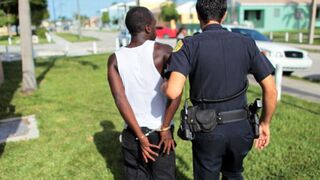 A Miami police officer makes an arrest while patrolling the streetsin August 2010. (Joe Raedle/Getty Images)