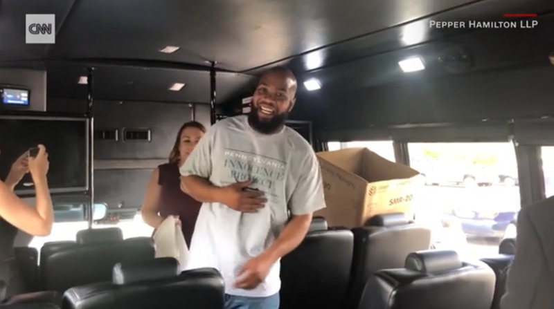 John Miller (center) boards a bus to take him home after being released from prison after 21 years.