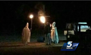 Cary Sharp and friends dressed as Ku Klux Klan members carrying torches near a cross in Lahoma, Okla., Oct. 31, 2015KOCO screenshot