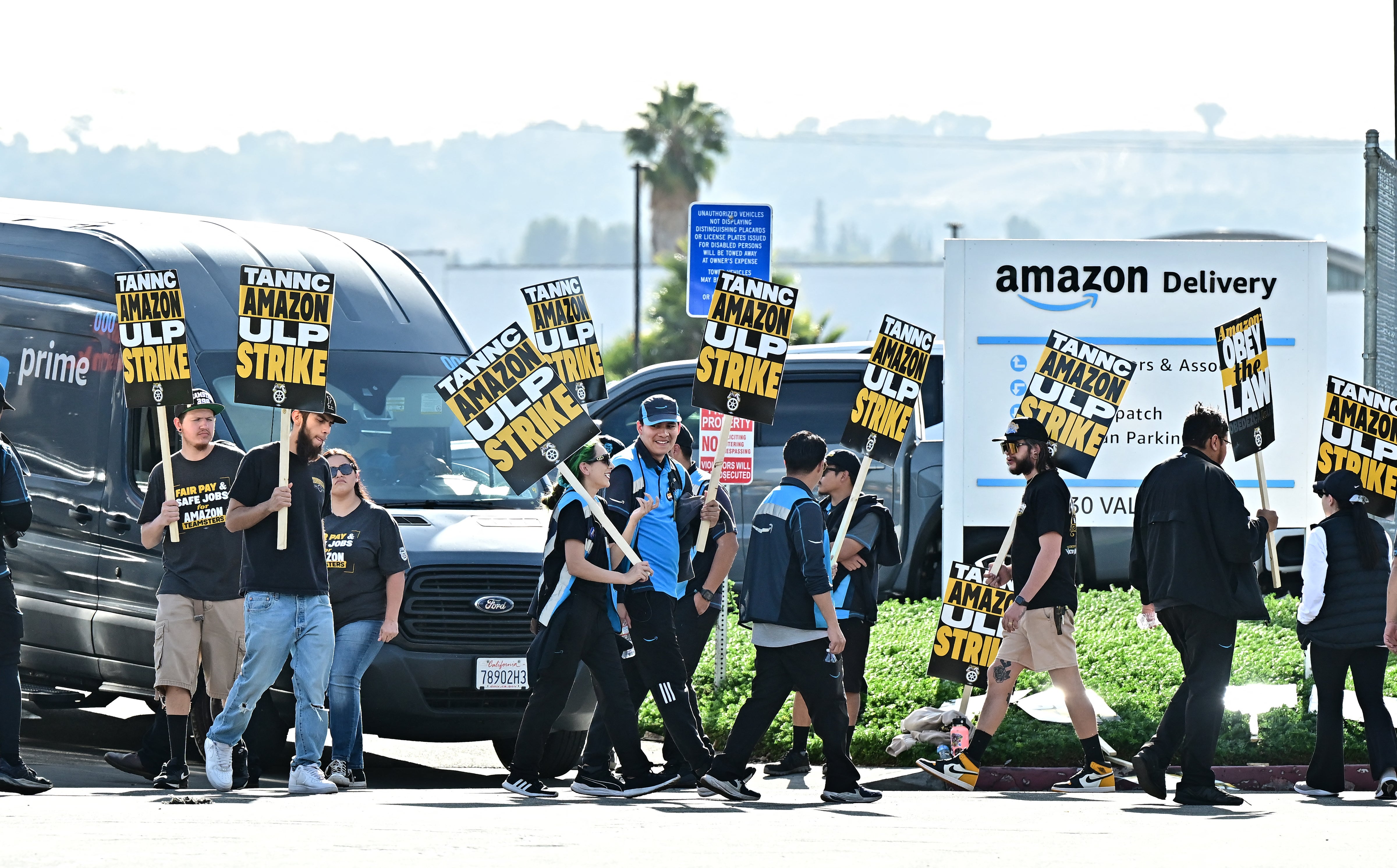 Amazon workers walk the picket line outside an Amazon facility in the City of Industry, California 