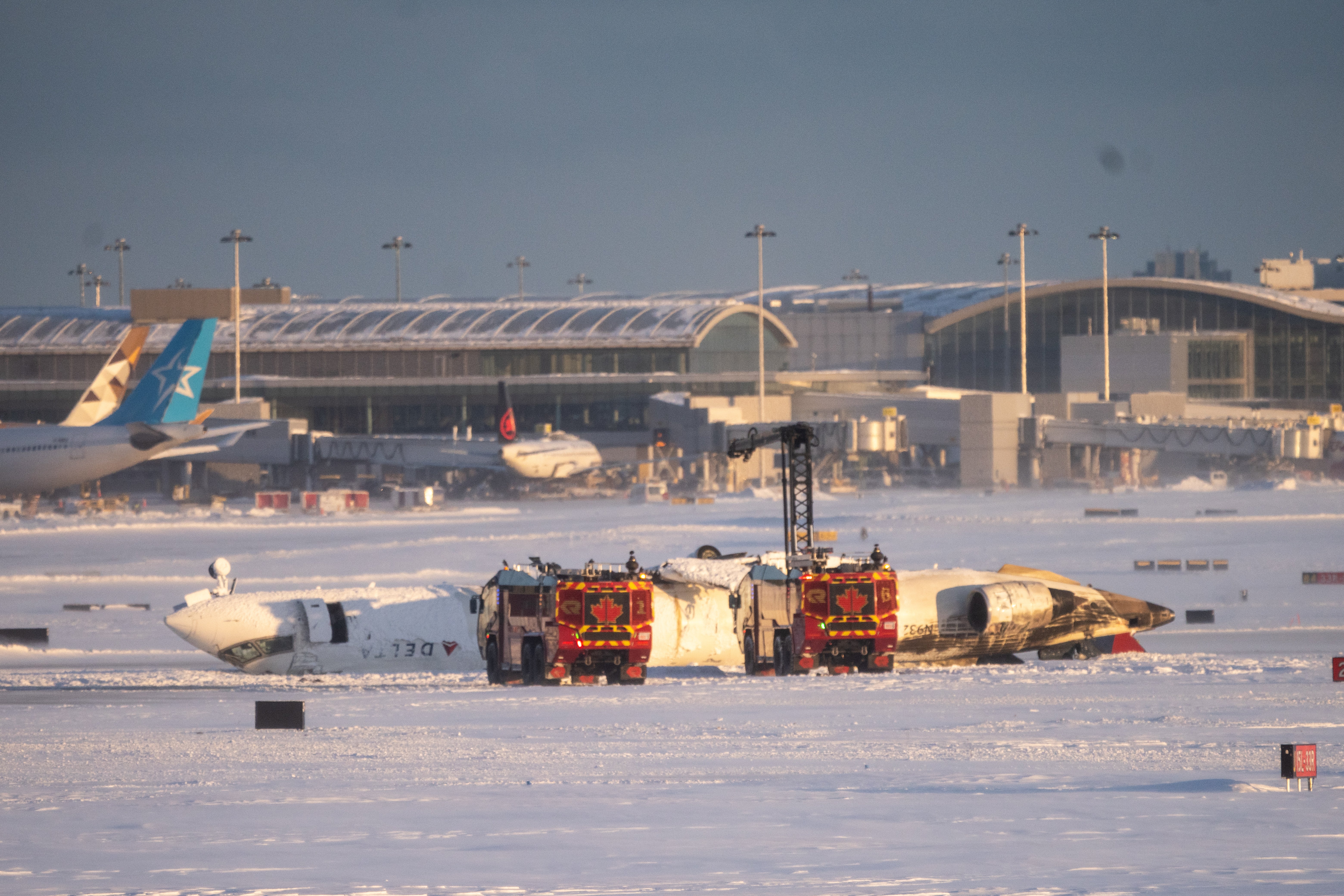 Image for A Delta plane crashed and flipped upside down in Toronto. Here's what to know