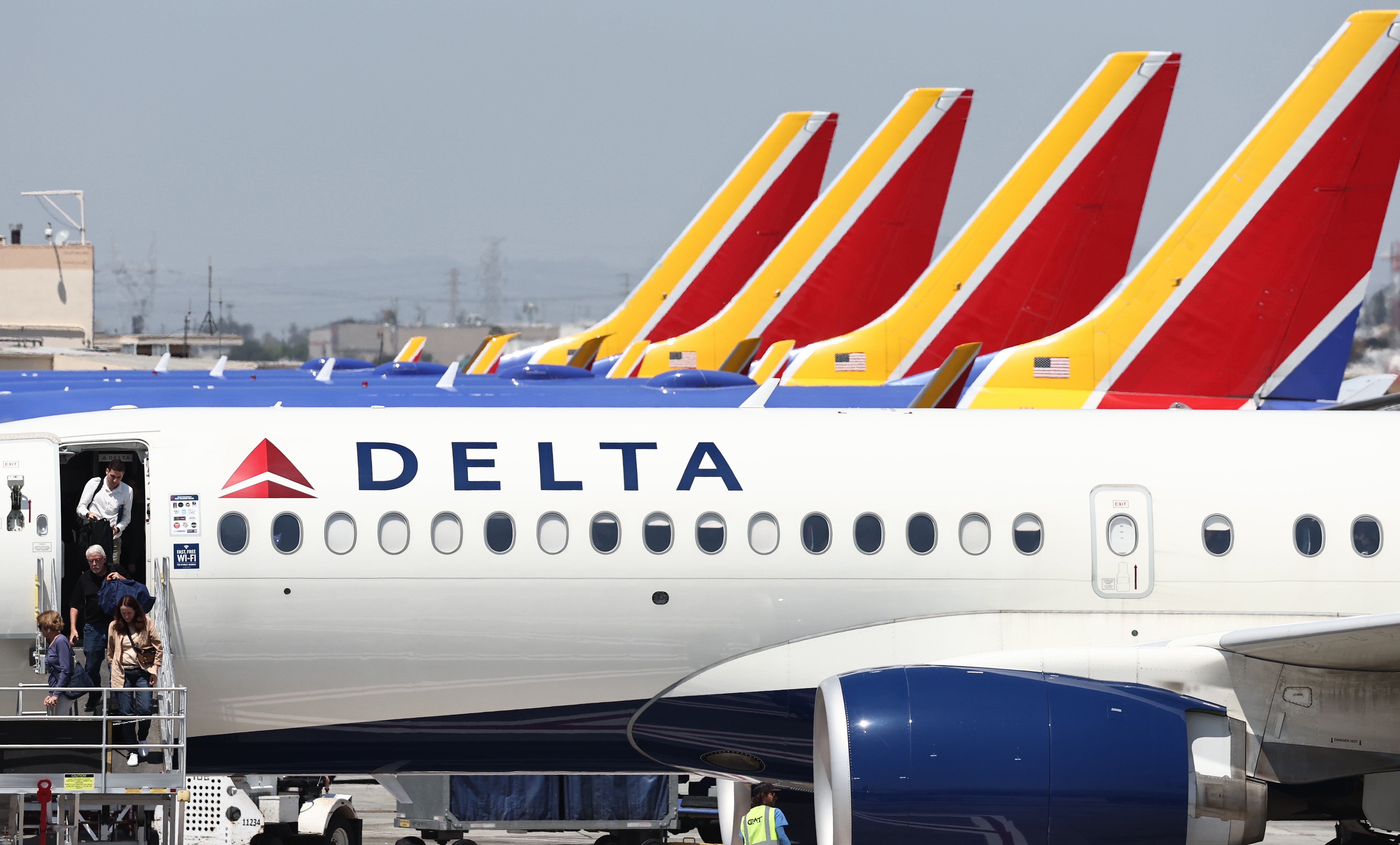 Image for Delta 'saw companies start to pull back.' Now airline stocks are falling