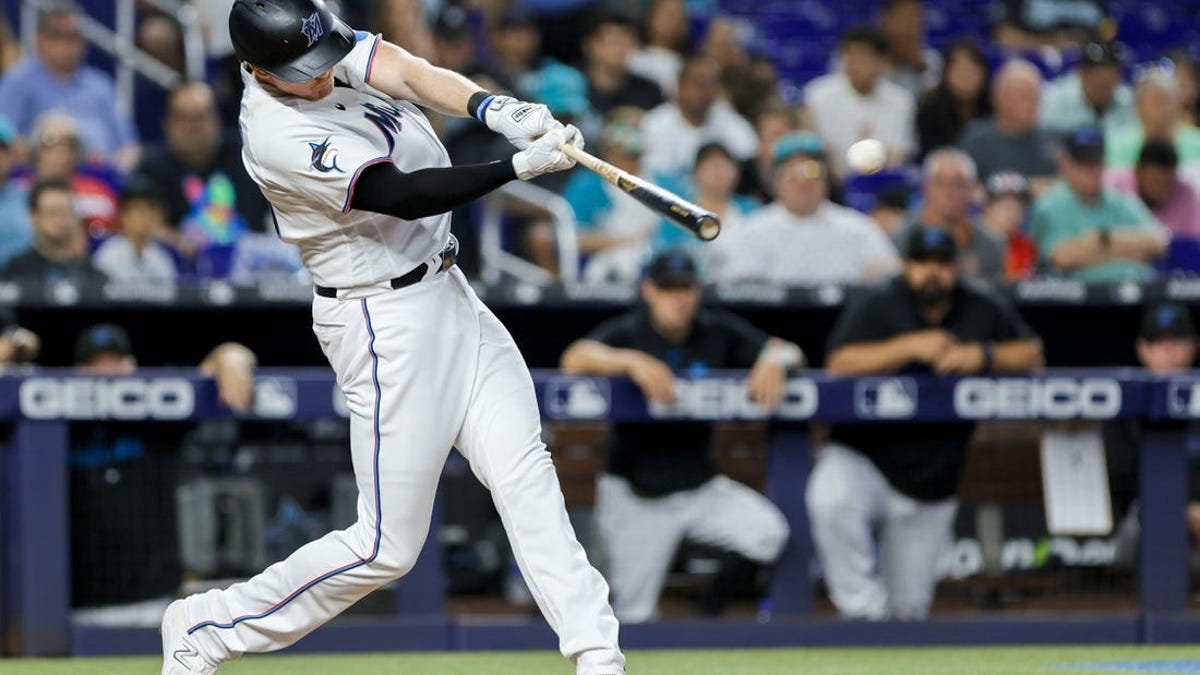 Miami Marlins first baseman Garrett Cooper (26) throws from the