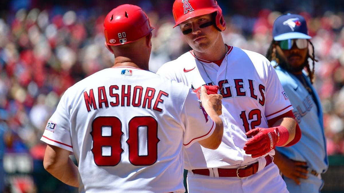 Los Angeles Angels' Hunter Renfroe (12) is greeted by Mike Trout