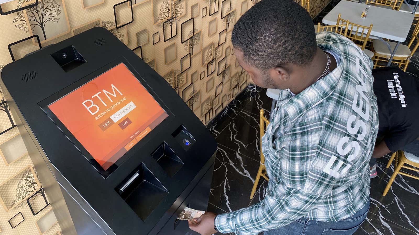 A bitcoin user buys bitcoins with naira on Bitcoin Teller Machine in Lagos, Nigeria Sept. 1, 2020.