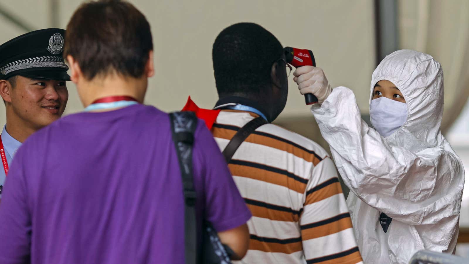 People have their temperature taken at the entrance of the Canton Fair in Guangzhou during the Ebola crisis in  2014.