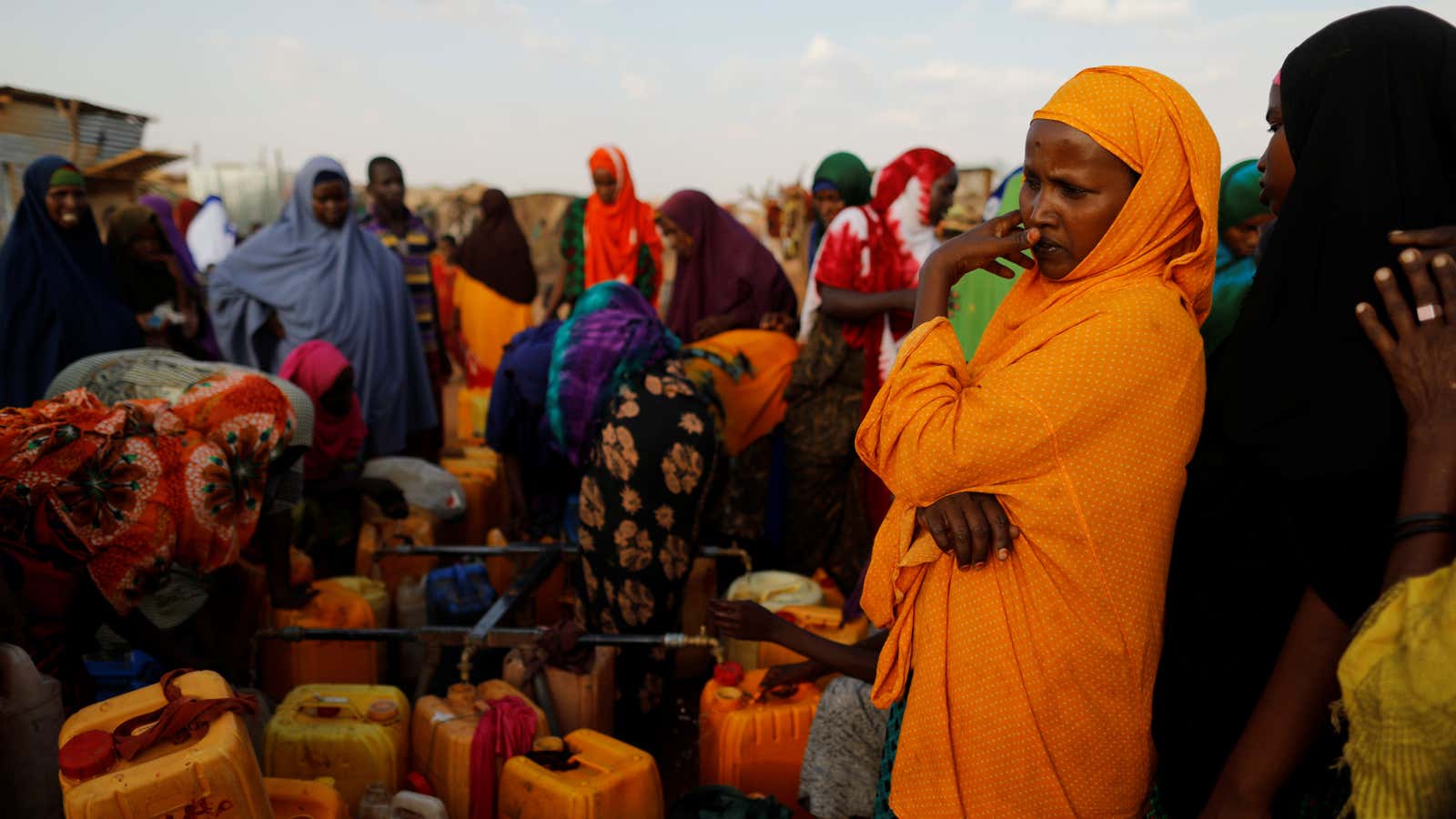 Displaced women from drought hit areas wait to fill their jerrycans as in Dollow, Somalia