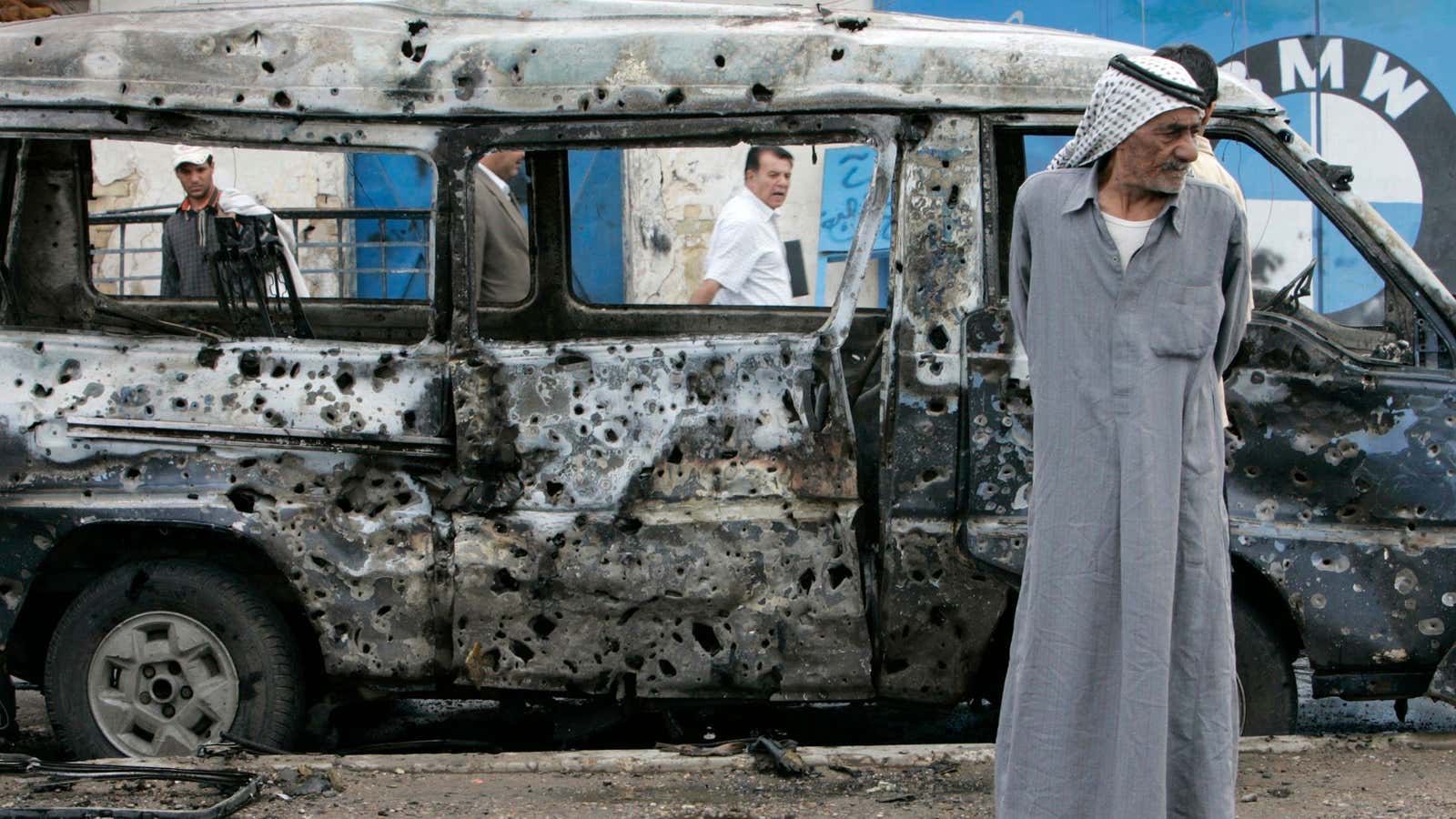 A man stands at the scene of a car bomb attack in Baghdad April 2, 2007. A car bomb killed two people and wounded nine…