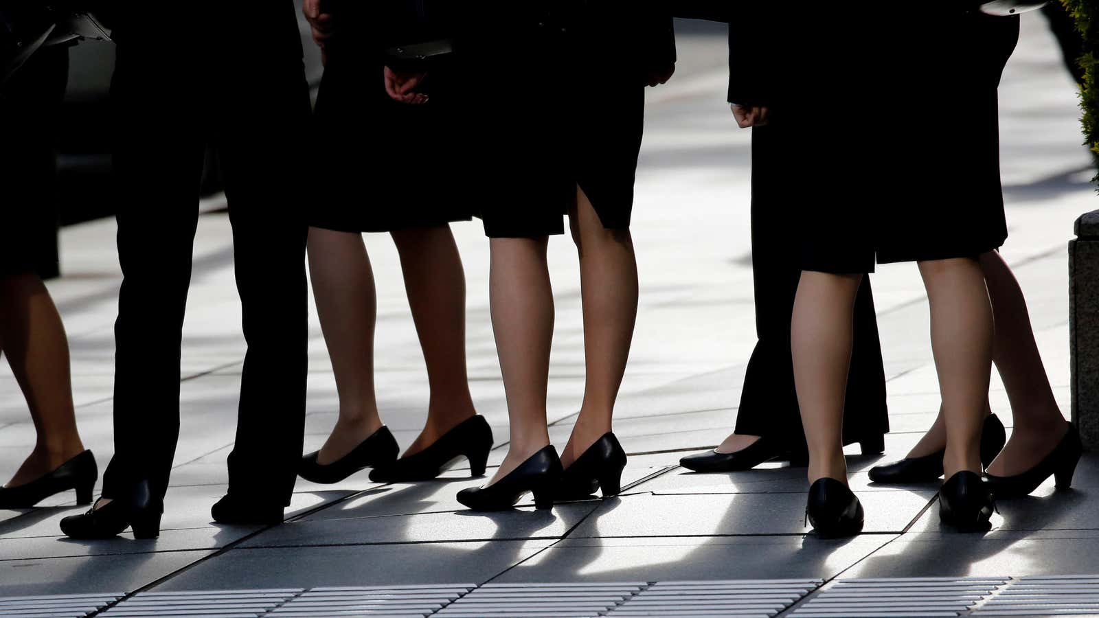 Female office workers wearing high heels, clothes and bags of the same colour are seen at a business district in Tokyo, Japan, June 4, 2019.