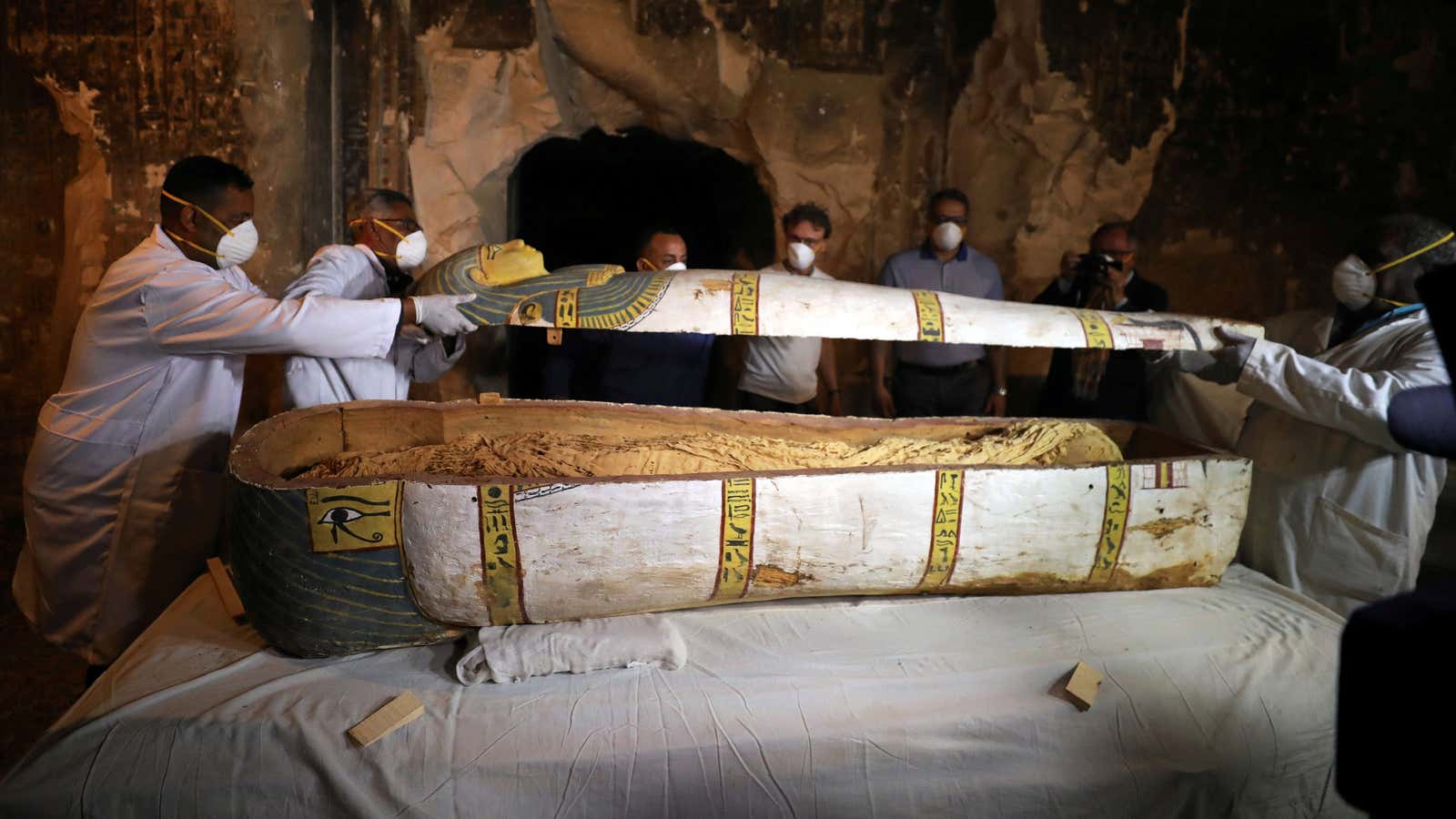 Local archaeologists remove the cover of an intact sarcophagus inside a tomb in Luxor, Egypt Nov. 24, 2018.
