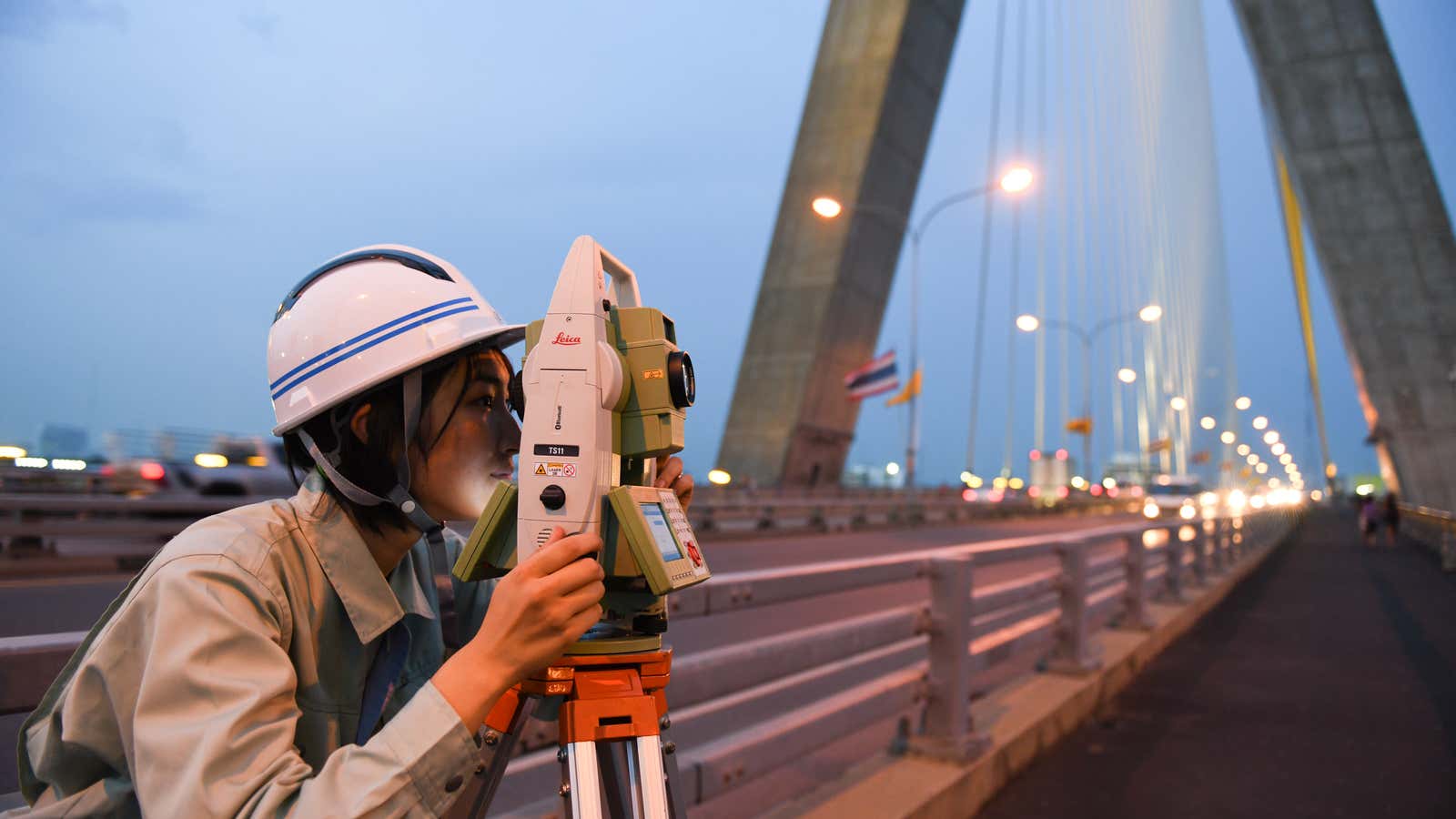 A view from a bridge—a technician from the Japanese tech company KUMONOS surveys Bangkok’s Rama VIII bridge pylon. Photos throughout by Noriko Hayashi.