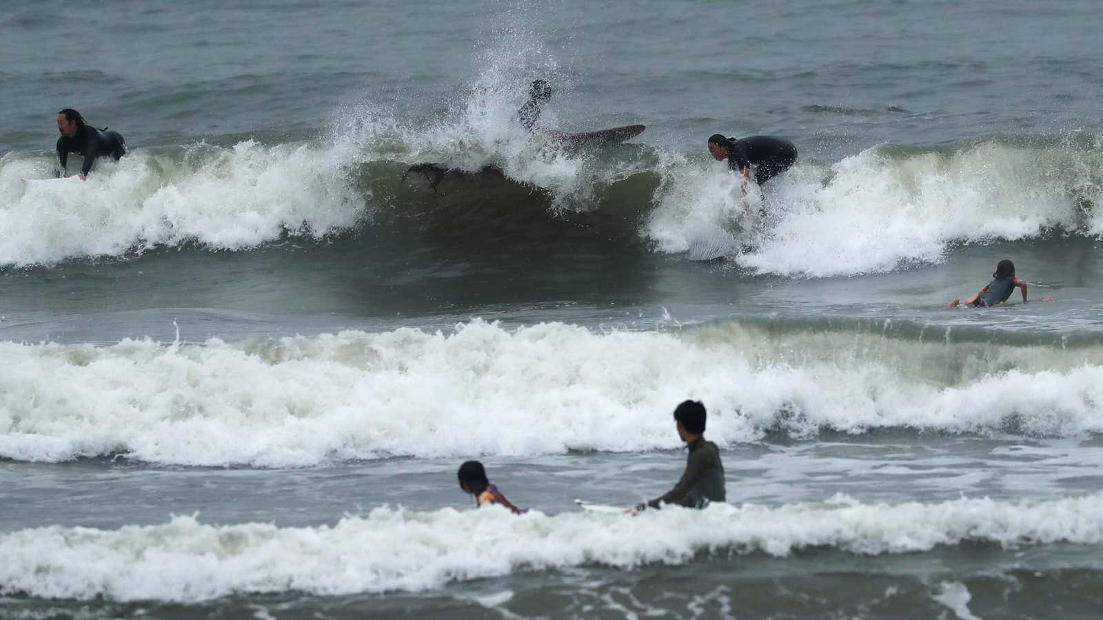 Surfers enjoy the waves near Tsurigasaki Beach, the surfing competition venue for the Tokyo 2020 Olympic Games that have been postponed to 2021 due to the coronavirus disease (COVID-19) pandemic, in Ichinomiya Town, Chiba prefecture, Japan July 1, 2021. REUTERS/Issei Kato