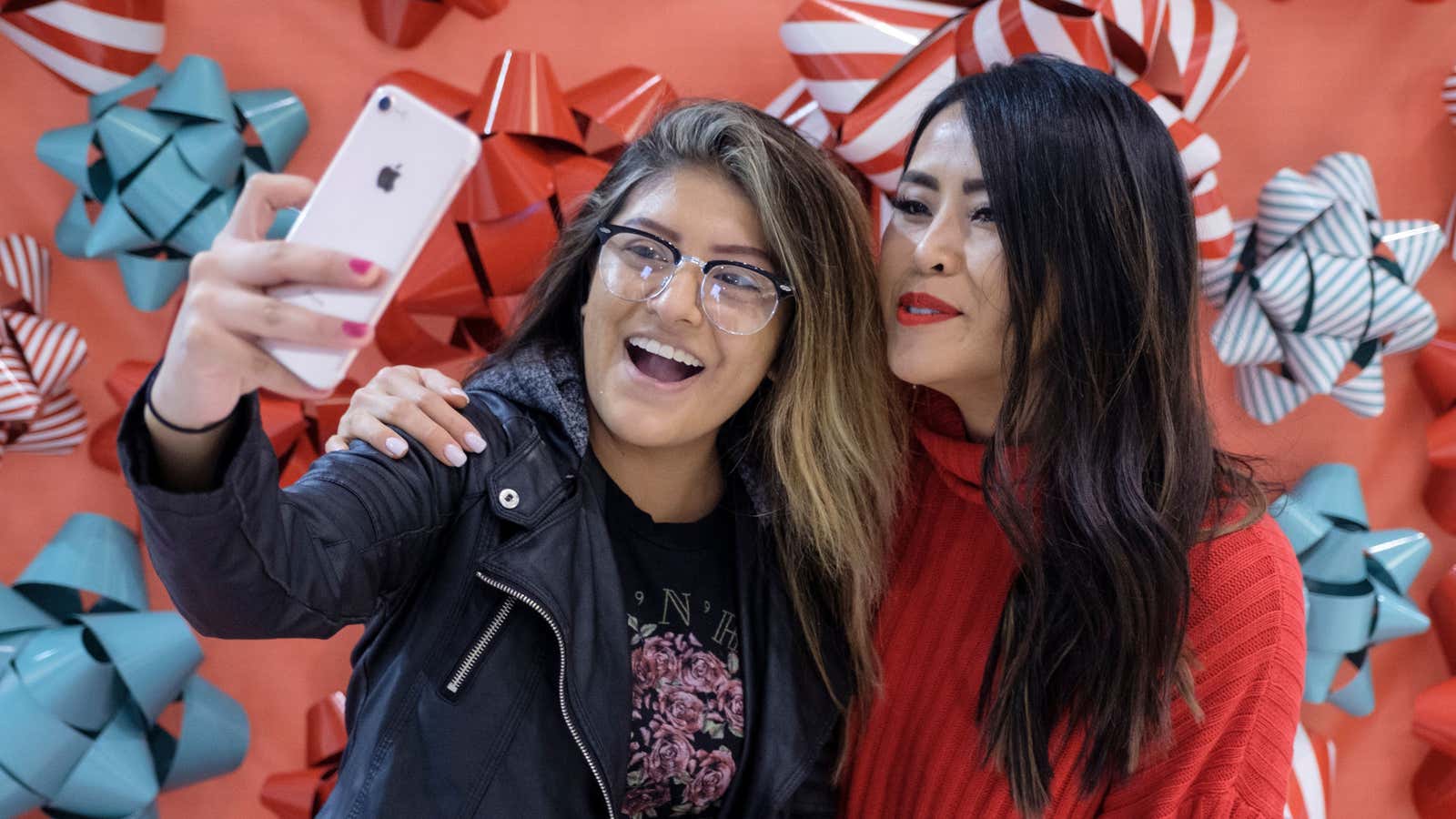 Social media influencer Sabrina Tan, right, poses with a shopper during a Sip n Shop event.