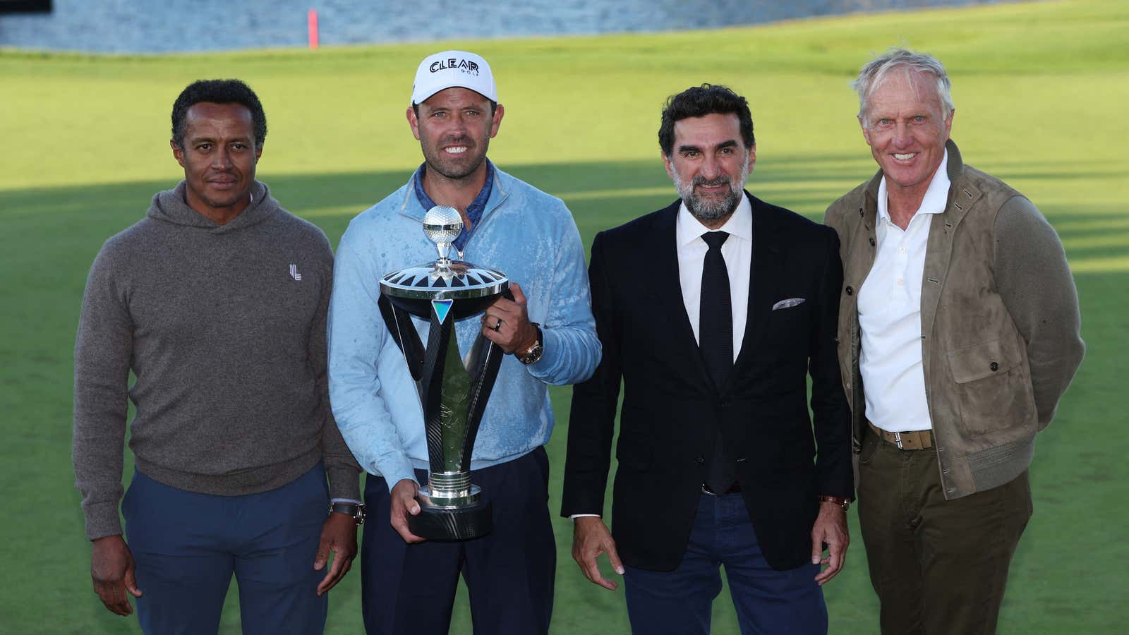 Charl Schwartzel poses with the chief executive of the Saudi Golf Federation Majed Al Sorour, Saudi Public Investment Fund governor Yasir Al-Rumayyan, and Chief executive of LIV Golf Investments Greg Norman after winning the inaugural LIV Golf Invitational.
