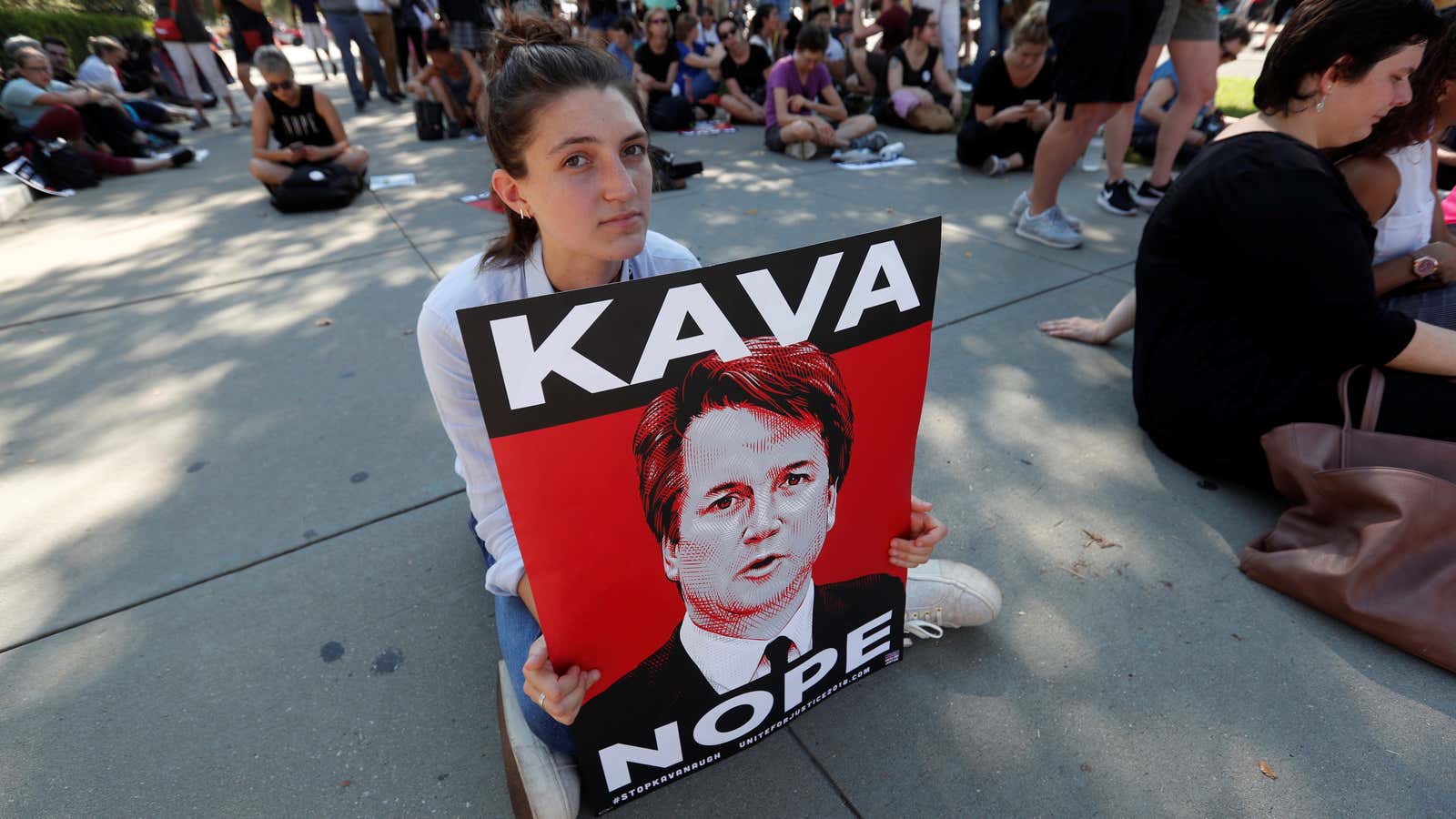 A demonstrator holds a sign opposing Kavanaugh.