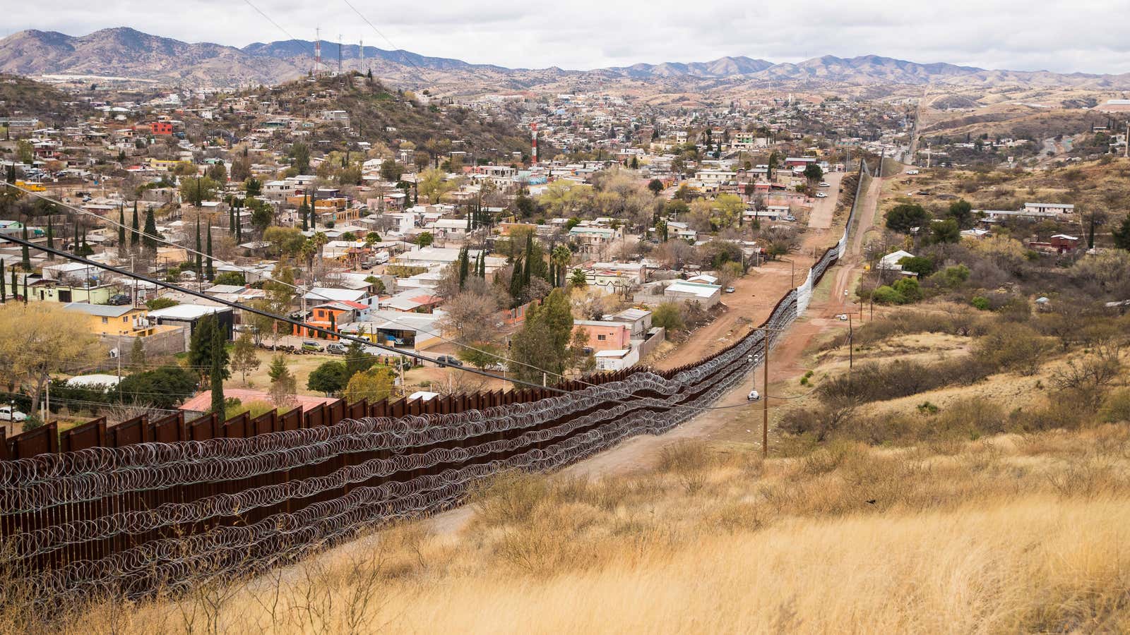 Concertina wire covers the US side of the border fence in Nogales, AZ.