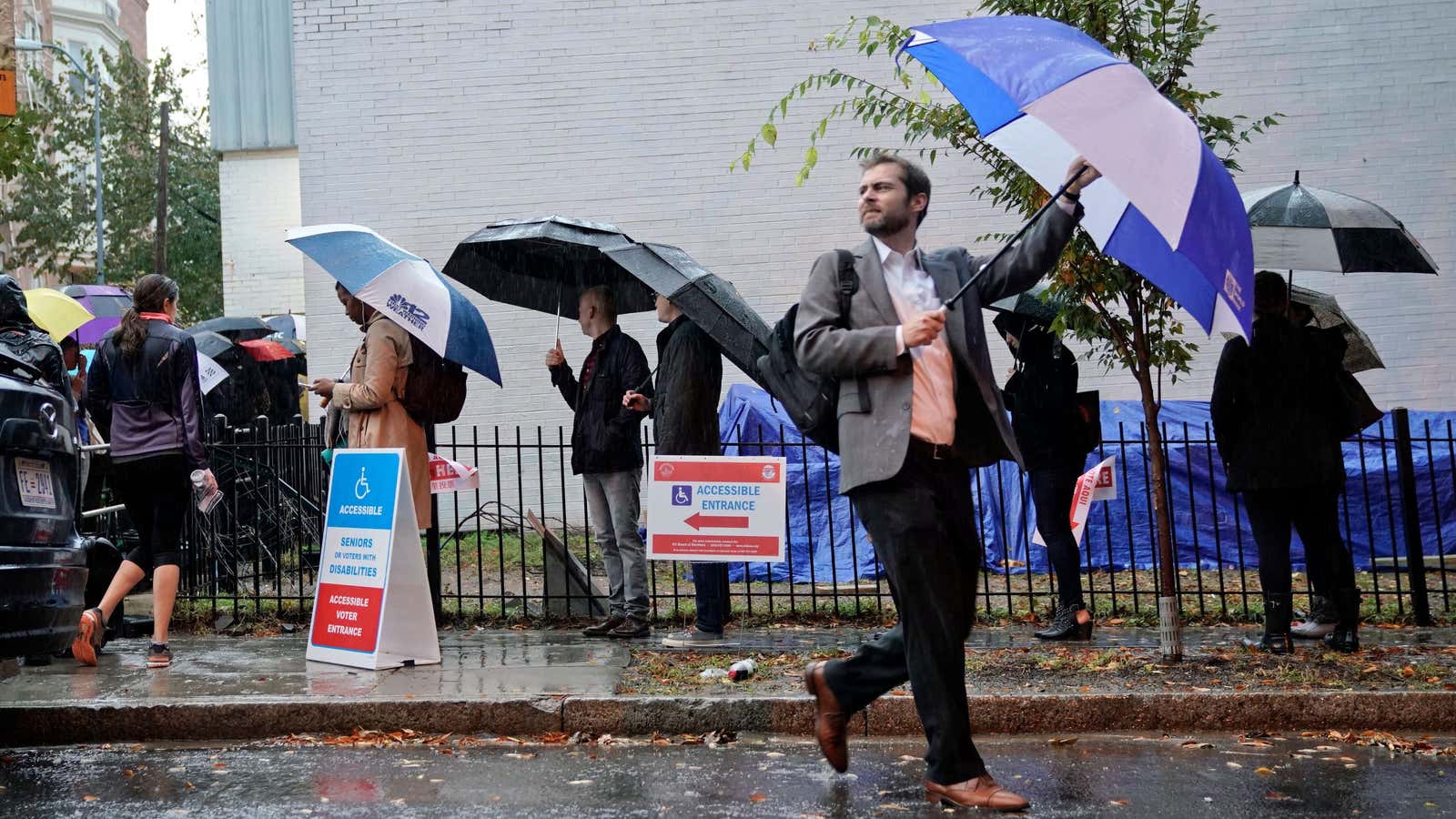 US midterm voters battle the rain in Washington, DC.