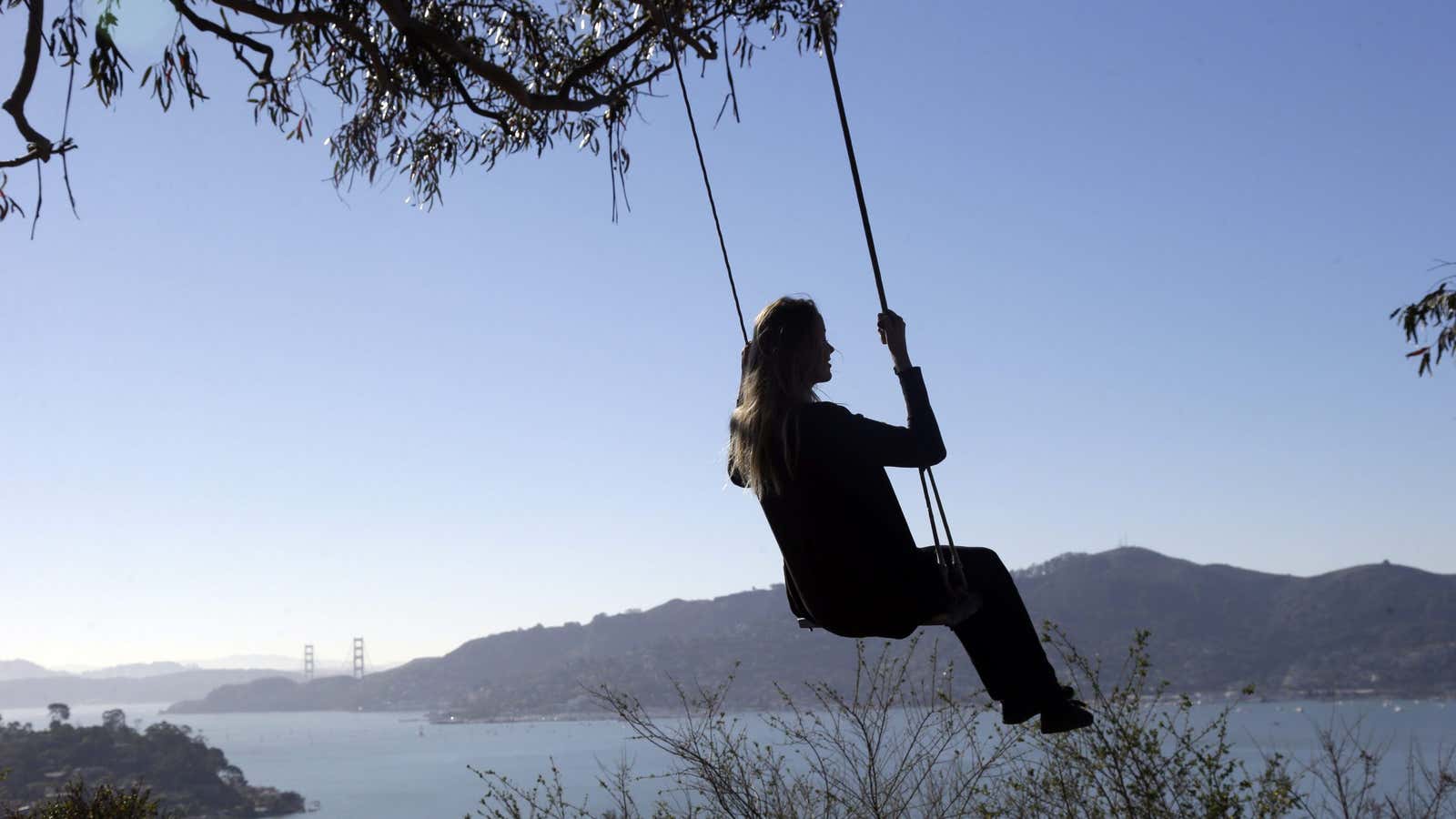 Karla, a visitor for Cologne, Germany, swings from the Hippie Tree, a popular visitor’s spot overlooking the San Francisco bay, on Thursday, Jan. 16, 2014,…