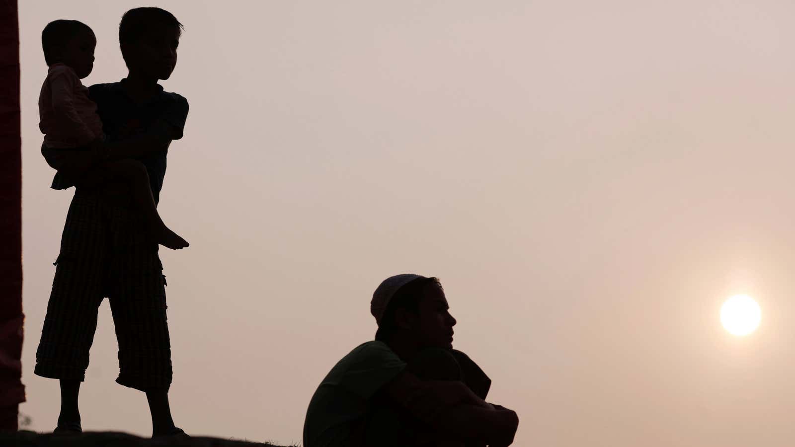 Rohingya refugee children watch a football game during sunset at Kutupalong refugee camp, near Cox’s Bazar, Bangladesh January 3, 2018.