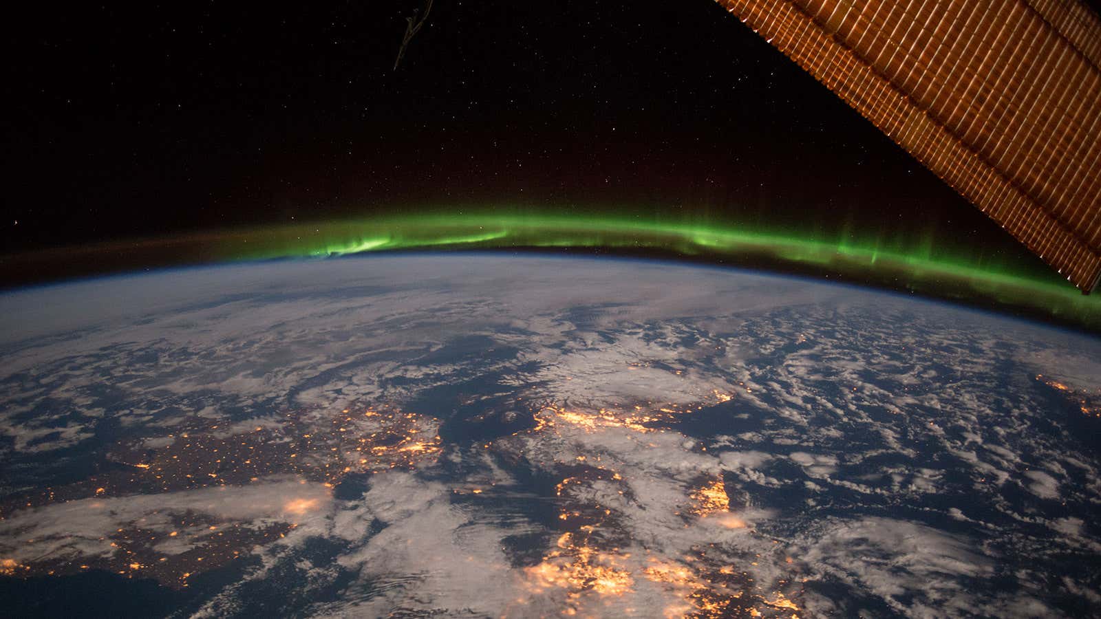 A moonlit night under an amazing and ever-changing aurora captured from the International Space Station by astronaut Terry Virts.