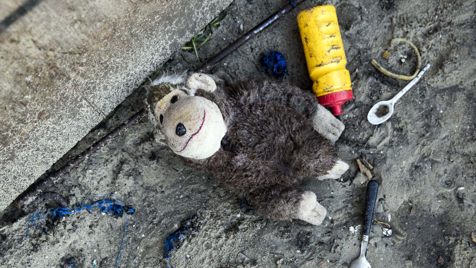 A plush toy lies on the ground after migrants fled the makeshift camp ‘The Jungle’ following the outbreak of a fire during dismantling operations a day earlier, in Calais on Oct. 27.