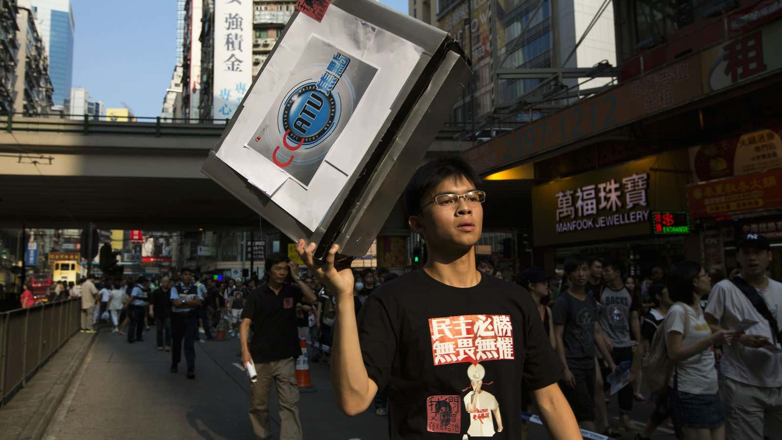 A protester holds aloft a paper television cut-out during a rally to demonstrate against the government’s decision not to award a broadcast license to Hong Kong Television.