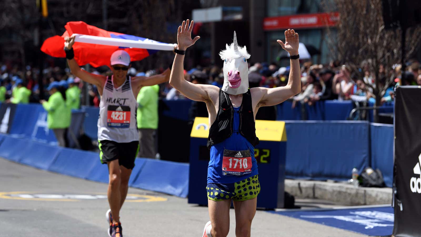 Apr 15, 2019; Boston, MA, USA; Adrian Spencer wears a unicorn mask as he crosses the finish line of the 2019 Boston Marathon. Mandatory Credit:…