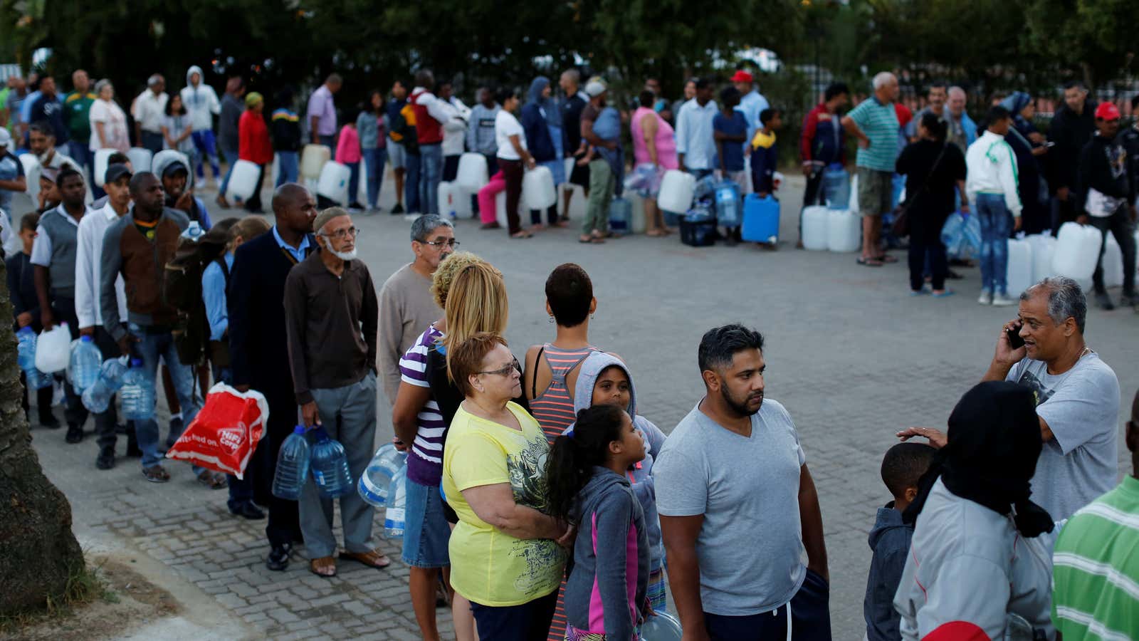 People queue to collect water from a spring in the Newlands suburb of Cape Town