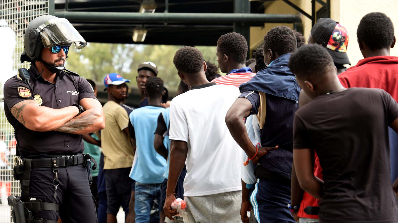 African migrants wait as they enter the immigrant center CETI in the Spanish enclave Ceuta